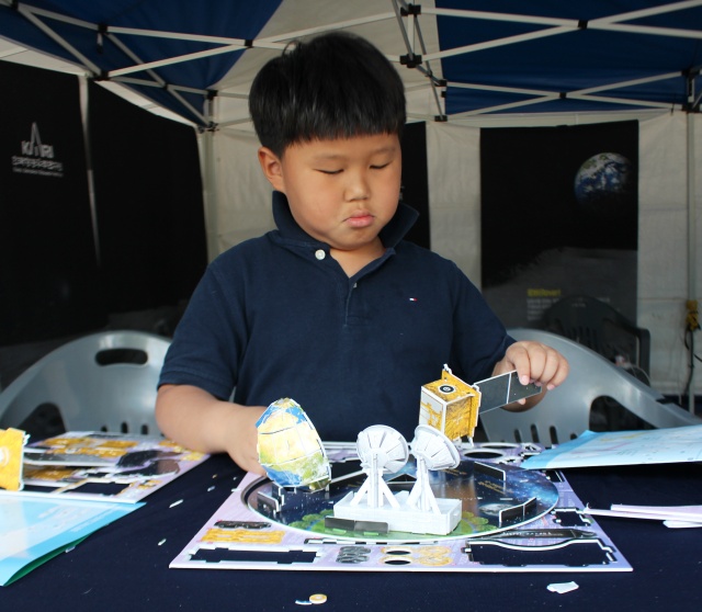 한국항공우주연구원 부스에서 초등학생이 원주율과 우주탐사 프로그램을 체험하고 있다. <사진=정민아 수습 기자>